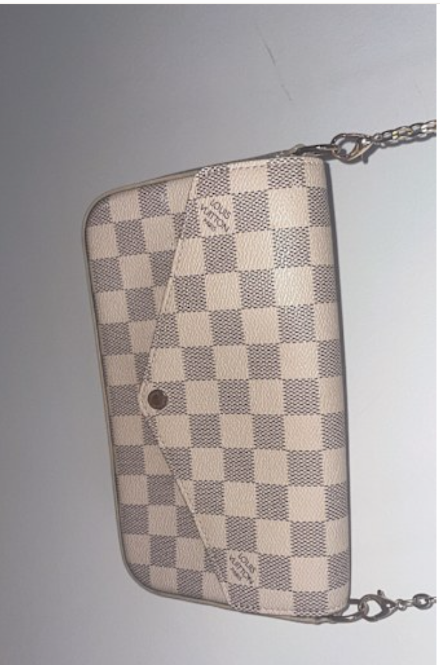 A compact Louis Vuitton beige checkered crossbody bag with a flap clos