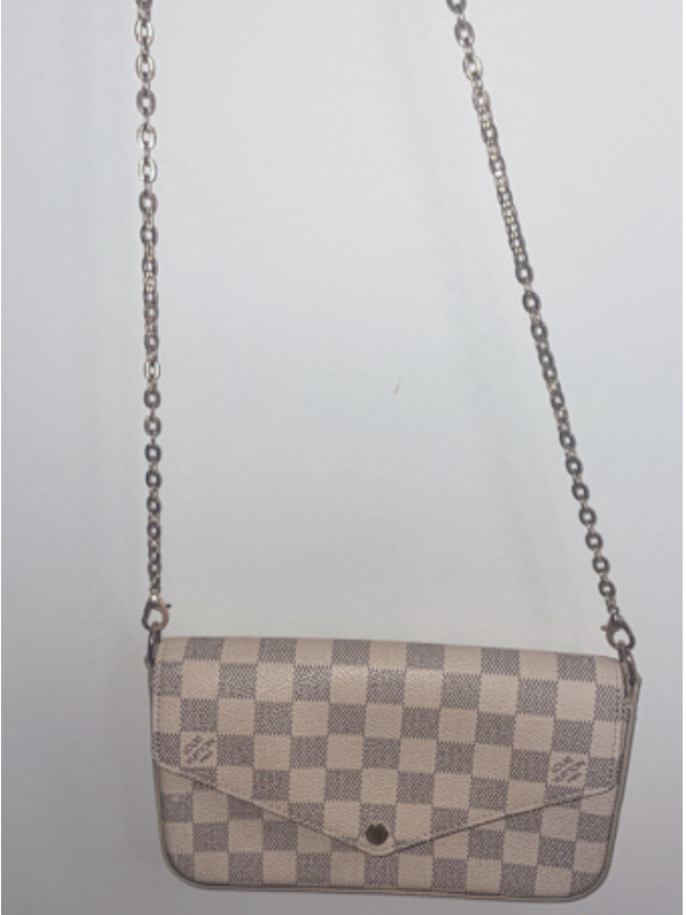 A compact Louis Vuitton beige checkered crossbody bag with a flap clos